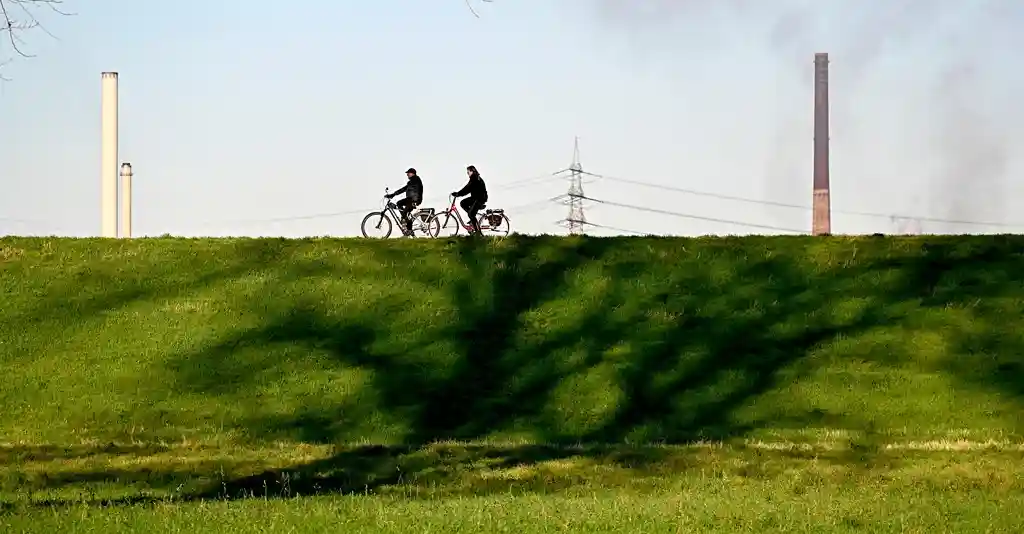 E-bike cyclists on Rhine Cycle Route family-friendly cycling path through European countryside